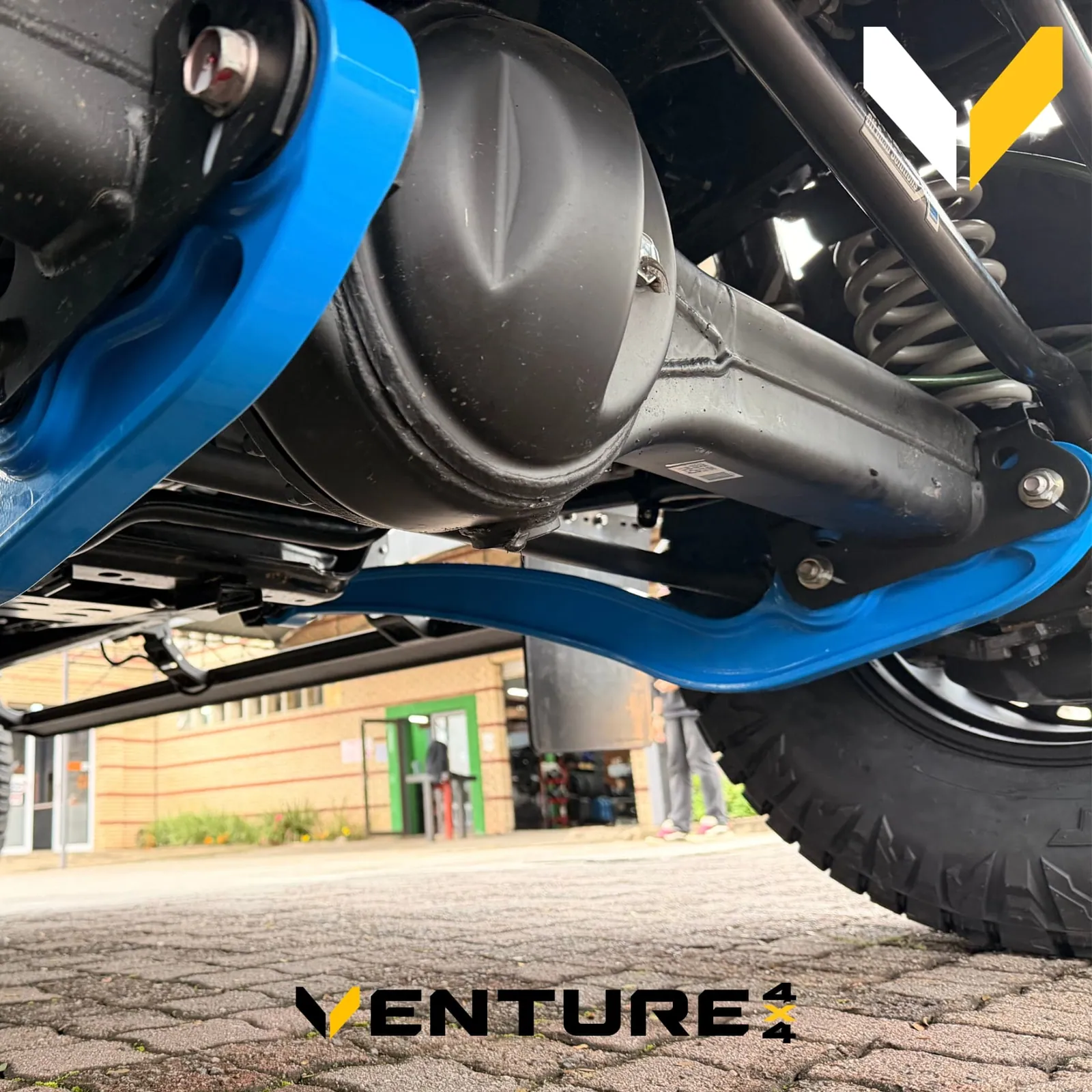 Blue JMACX coil conversion arms and airbag under a Land Cruiser 79