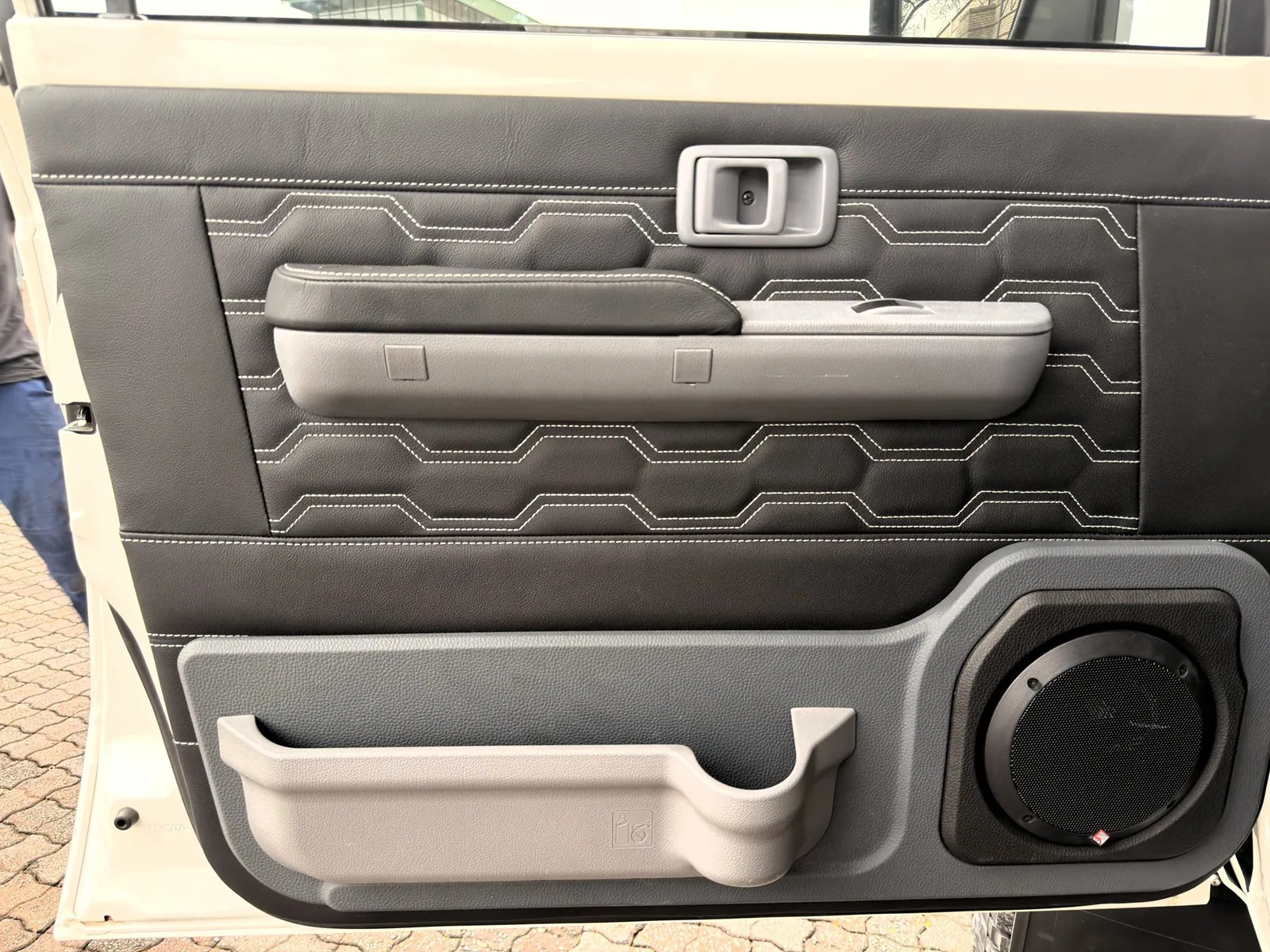 Custom stitched leather door trim with upgraded speaker