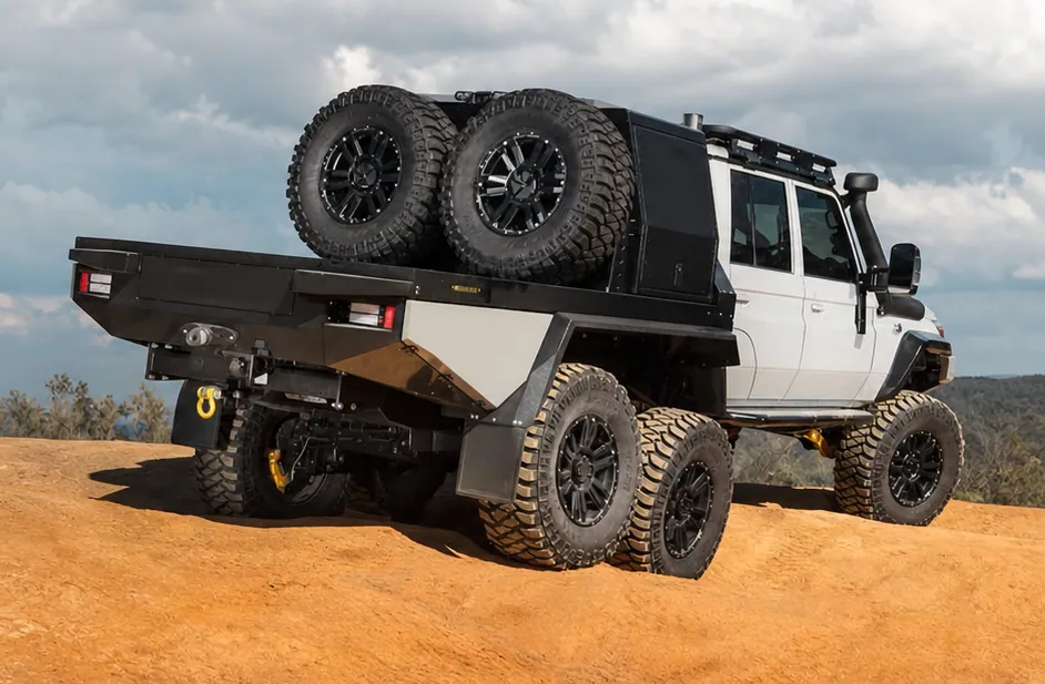 JMACX 6x6 Land Cruiser 79 tray build with all three axles on a rocky ridge