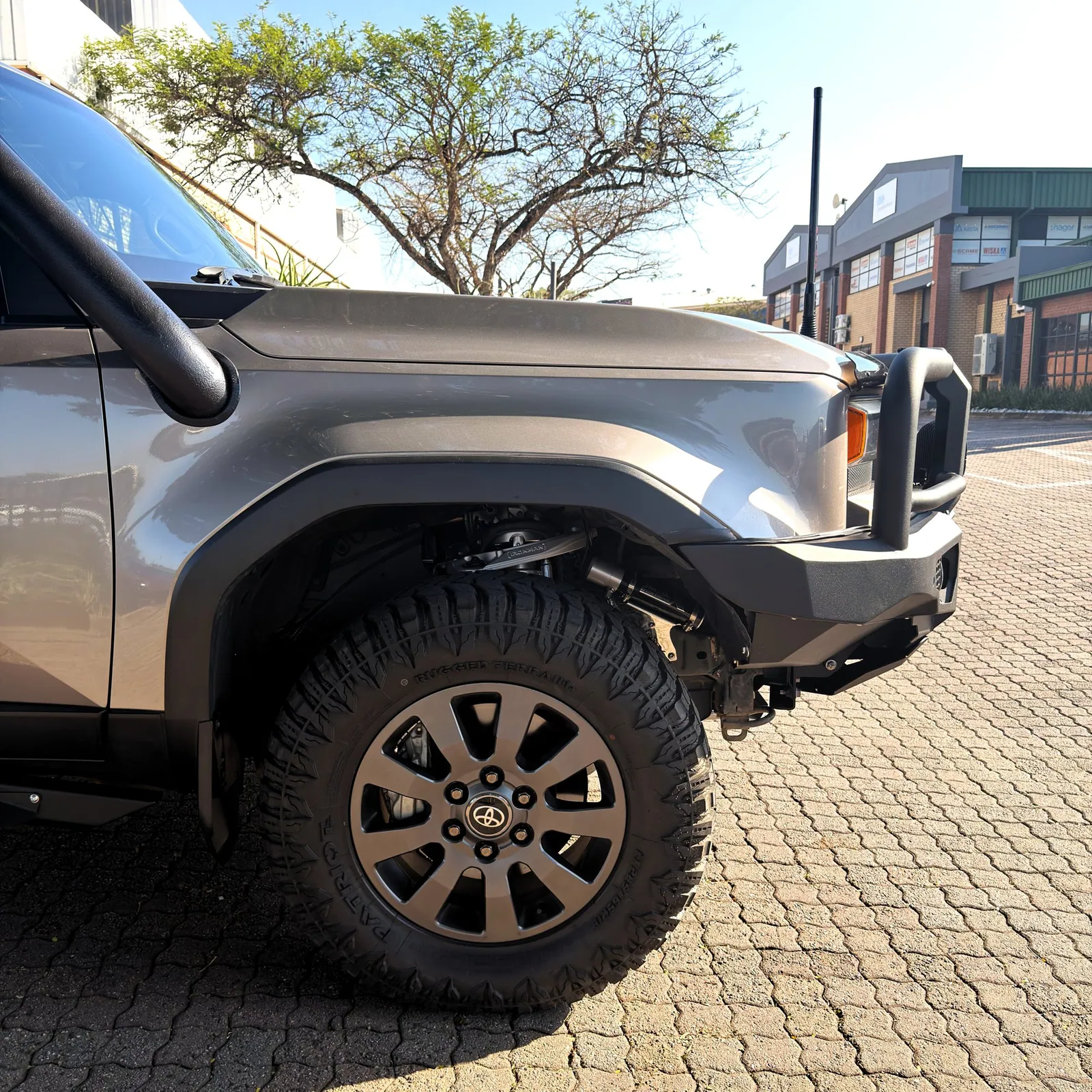 Front quarter view showing the raised stance and all-terrain tyres