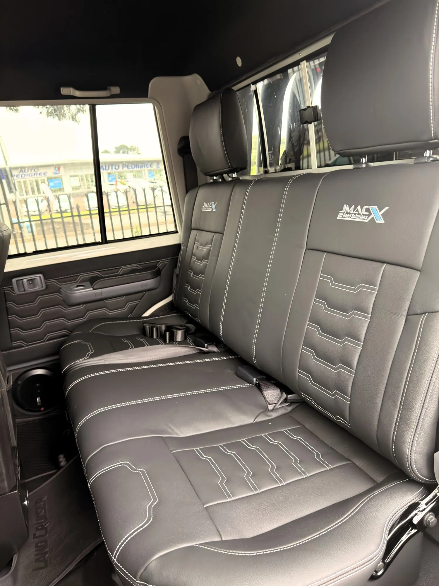 JMACX-branded leather rear bench seat